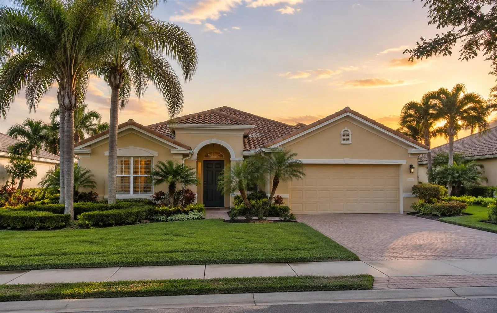 Florida stucco home with a tile roof at sunset